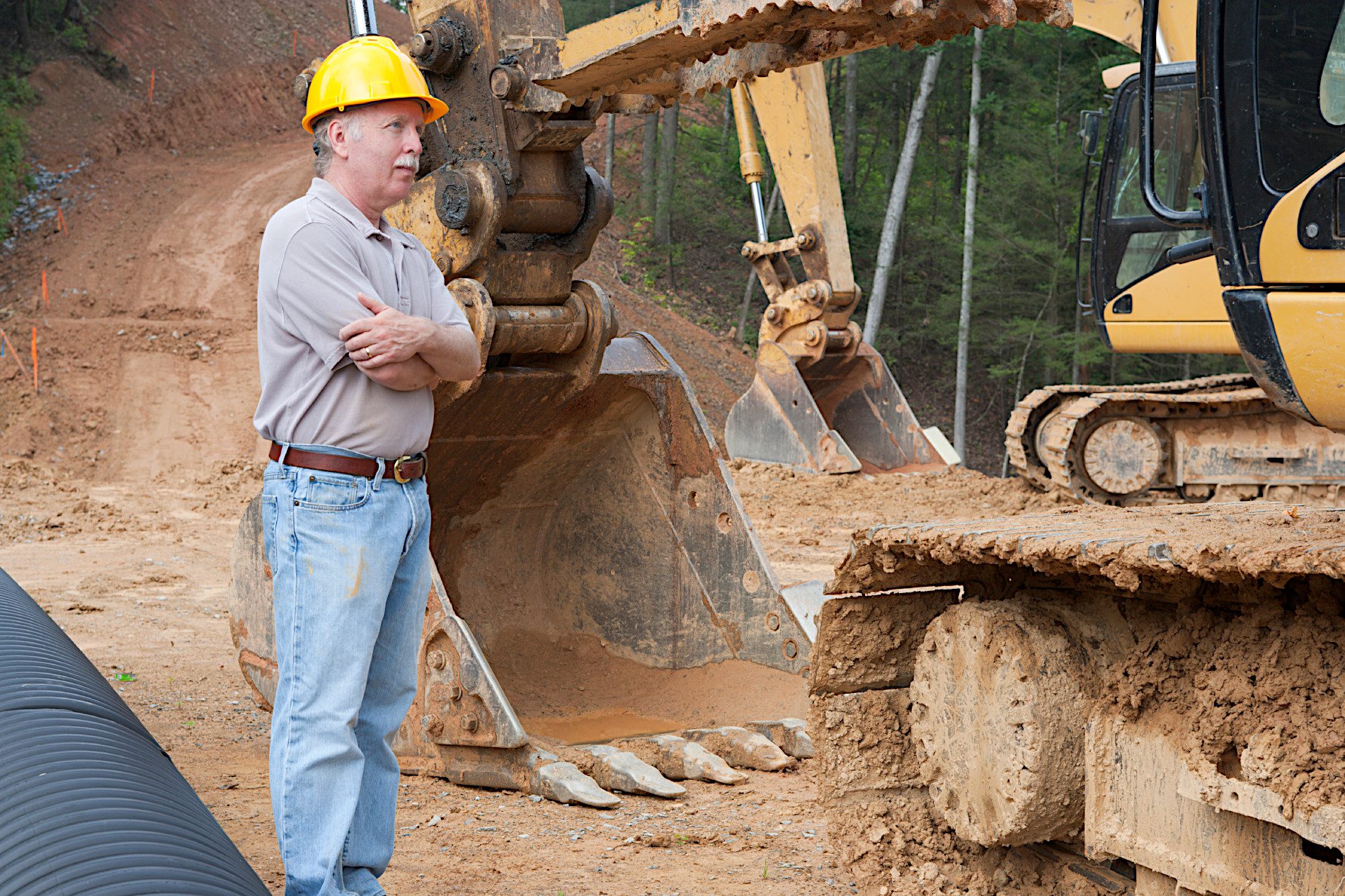 A foreman oversees his job site using leased equipment